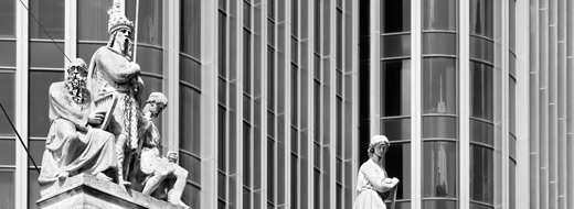 Statues in front of a brand new building.