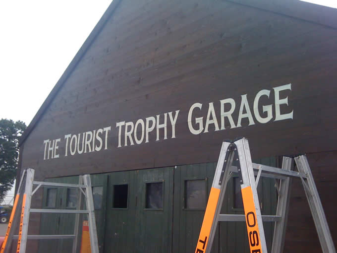 painted sign the tourist trophy garage