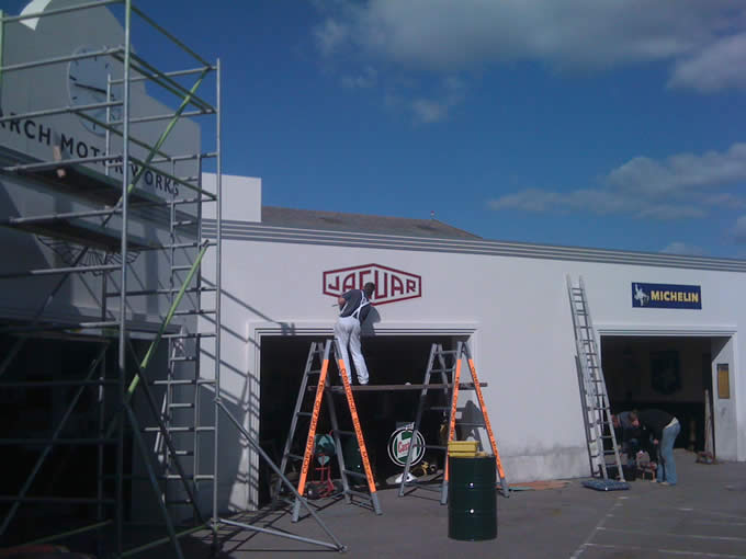 Signwriters working on the March Motor Works exhibit