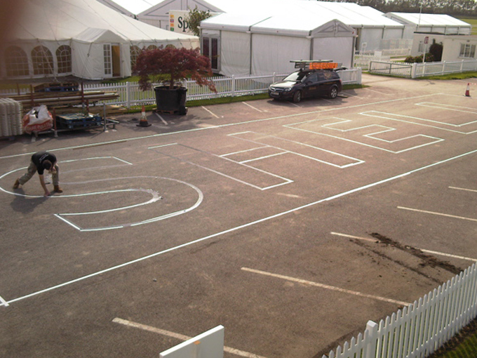 hand drawn shell logo onto racetrack