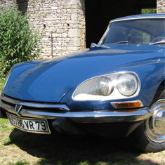 a Citroen DS parked in the courtyard